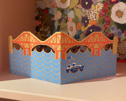 Forth Bridge card design on a shelf
