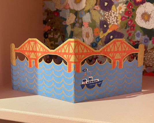 Forth Bridge card design on a shelf