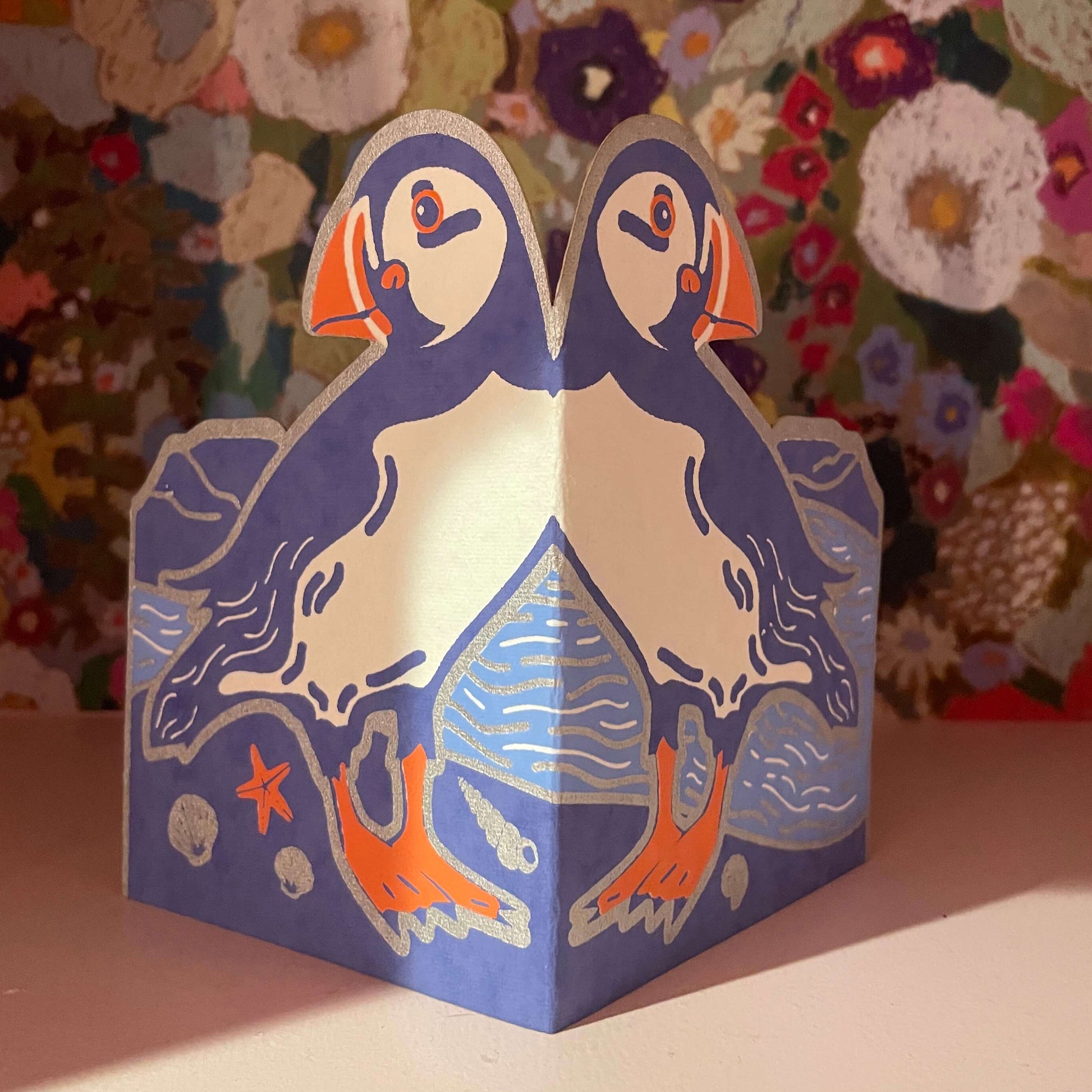 Card with puffin design on a floral background